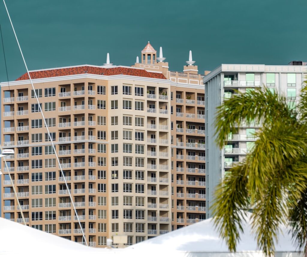 a tall building sitting next to a palm tree