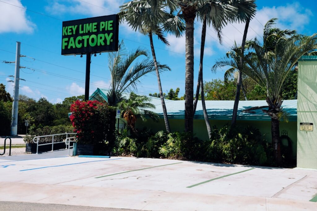 Key lime pie factory sign among palm trees